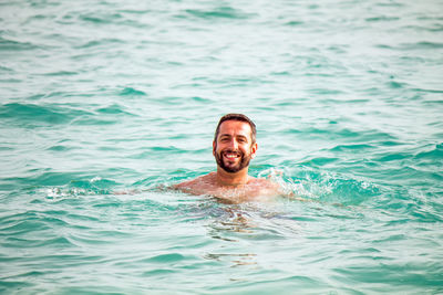 Portrait of young man swimming in pool