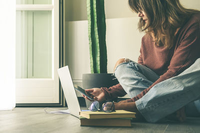 Young woman working on laptop at home. teenager making an internet video call with remote friends. 