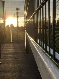 Railroad tracks in city at sunset