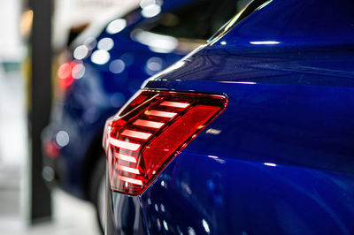 Close-up of illuminated red car in city