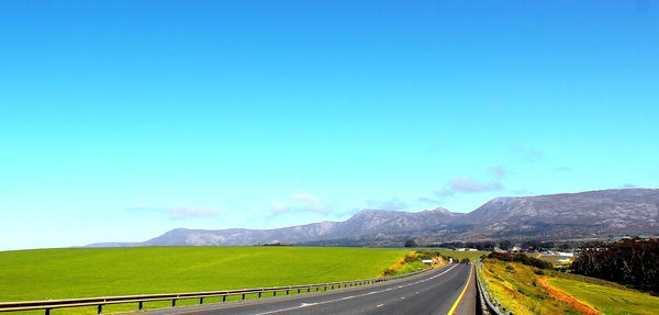Empty road along countryside landscape