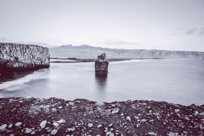 Scenic view of lake against sky during winter