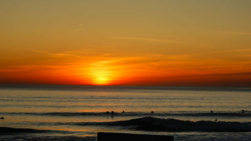 Scenic view of sea against romantic sky at sunset