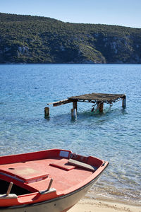 Boat moored on sea against sky