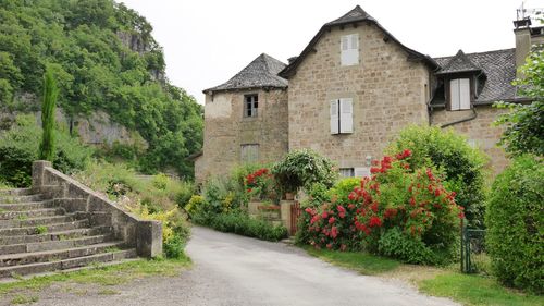 Street amidst houses and buildings against sky