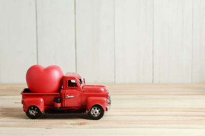 Close-up of toy car on table against wall