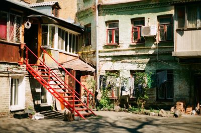 Old building by street in city