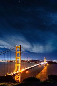 Low angle view of suspension bridge at night