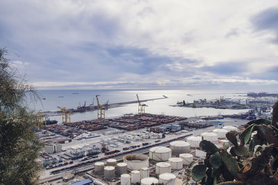 High angle view of buildings and sea against sky