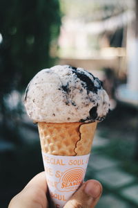 Hand holding ice cream in glass