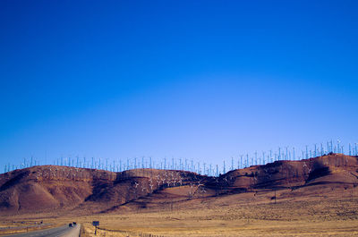 Scenic view of land against clear blue sky