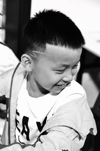 Close-up of boy smiling while sitting in classroom