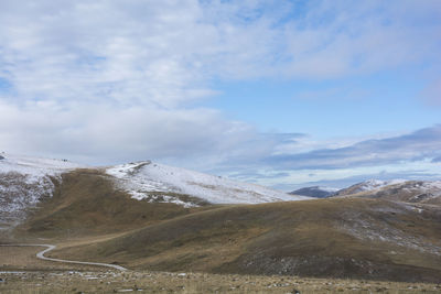 Scenic view of snowcapped mountains against sky