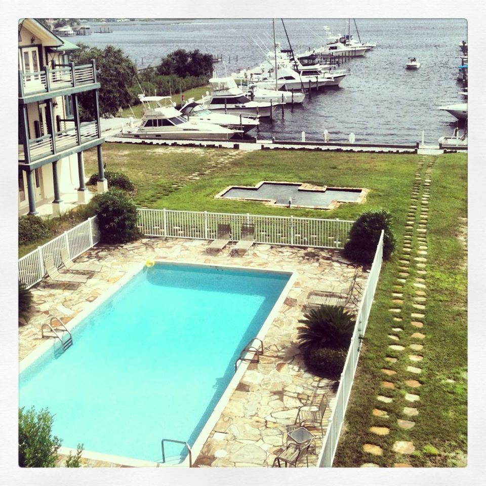 HIGH ANGLE VIEW OF SWIMMING POOL WITH BUILDINGS