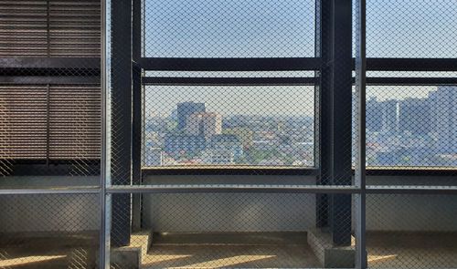 Full frame shot of building seen through chainlink fence