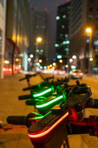 Close-up of dumbbells on street at night