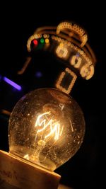 Close-up of illuminated lighting equipment against black background