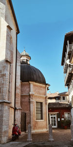 Low angle view of historic building with vespa