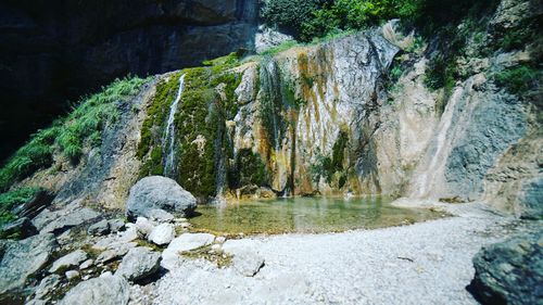 Scenic view of stream flowing through rocks