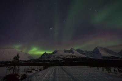 Scenic view of aurora borealis over lyngen alps