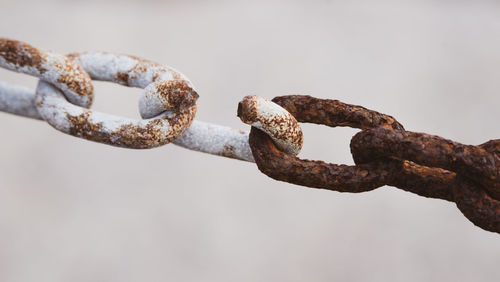 Close-up of rusty metal chain against clear sky
