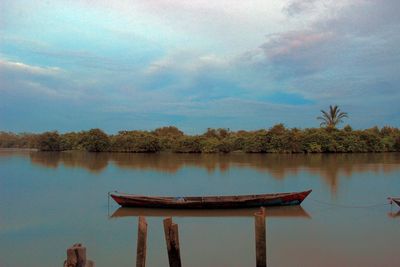 Gazebo by lake against sky