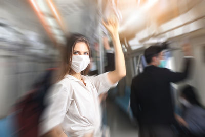 Blurred motion of woman standing by train