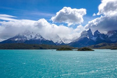 Scenic view of sea and mountains against sky