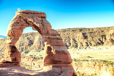 Rock formation against clear blue sky