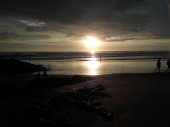 Scenic view of beach against sky during sunset