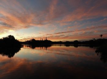 Scenic view of lake against orange sky