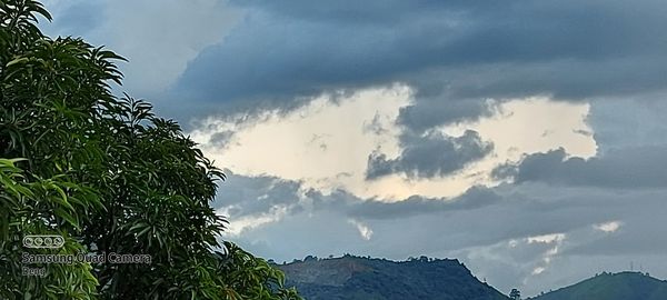 Low angle view of silhouette mountains against sky