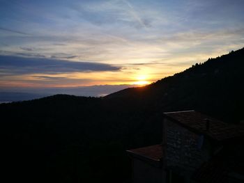 Scenic view of mountains against sky at sunset