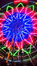Low angle view of illuminated ferris wheel at night