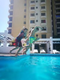 Low angle view of woman jumping in swimming pool