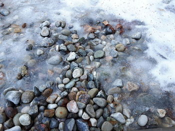 Close-up of pebbles on sand