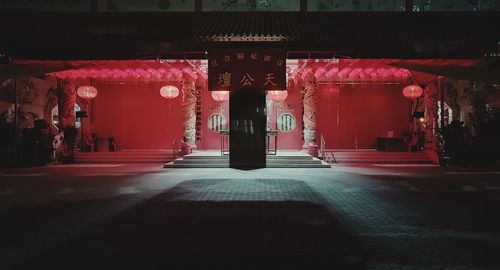 Empty corridor in building at night