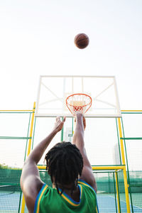 Black man playing basketball game