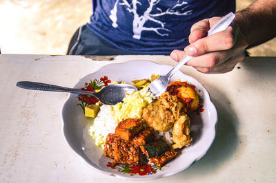 Close-up of man holding food on table