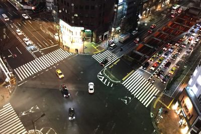 High angle view of vehicles on city street at night