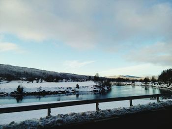 Scenic view of lake against sky during winter