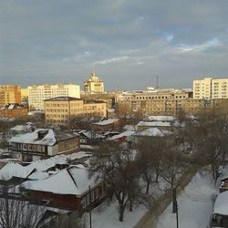 Buildings against cloudy sky