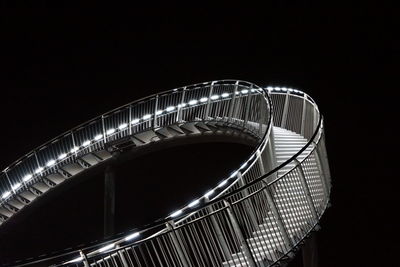 Low angle view of illuminated ferris wheel against sky at night