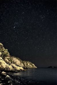 Scenic view of sea against clear sky at night