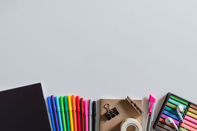 Directly above shot of office supplies over white background