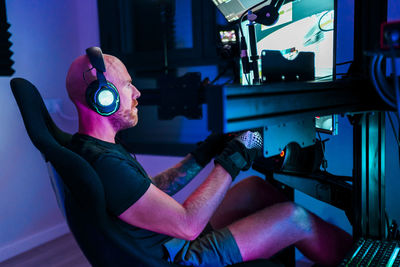 Bald man playing game at studio