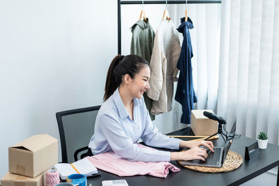 Young woman using laptop at home