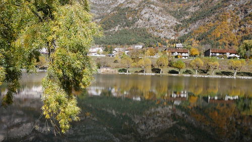 Scenic view of lake by trees and buildings