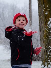 Smiling girl standing in snow