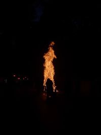 Silhouette of fire burning at night